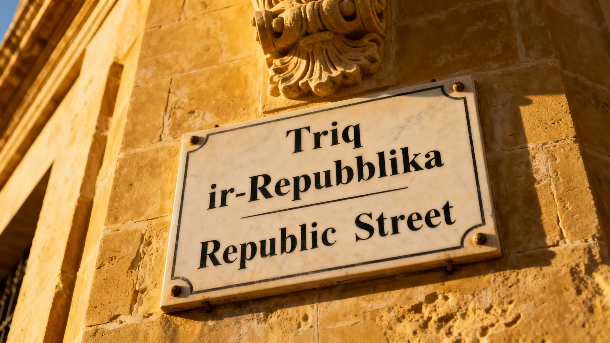 A bilingual street sign in Valletta showing the Maltese name above the English translation