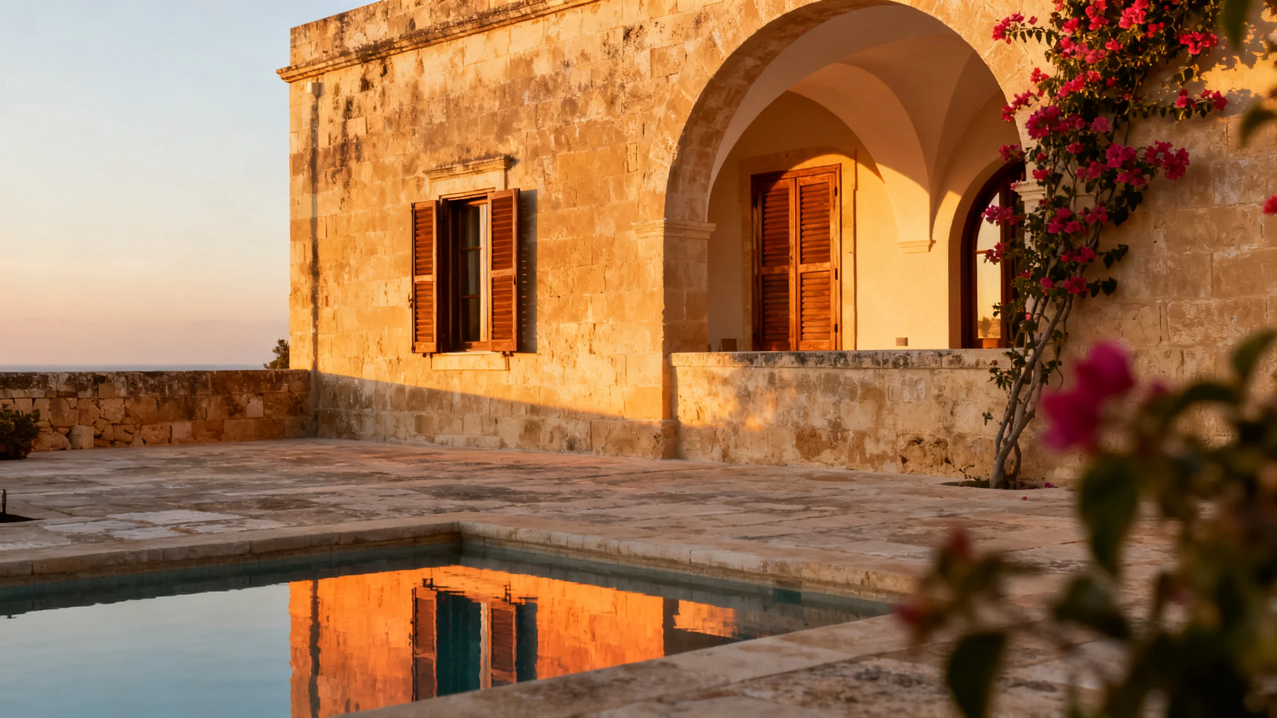 A converted Gozitan farmhouse with limestone walls, a small private pool, and traditional shutters opening onto a courtyard
